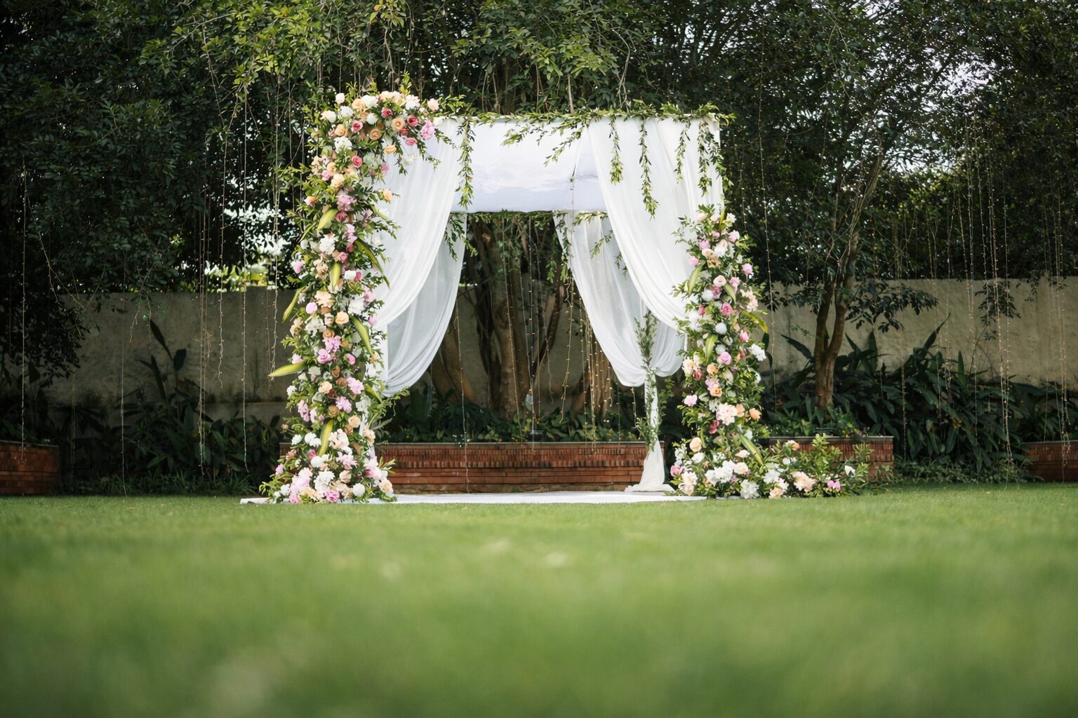 White-draped ceremony canopy on the lawn