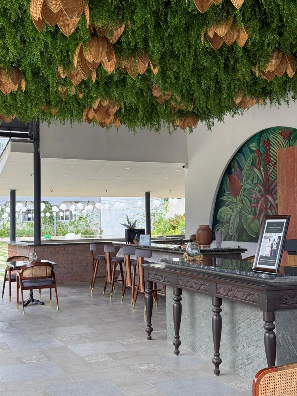 Botanical ceiling and circular mural beside the reception lounge