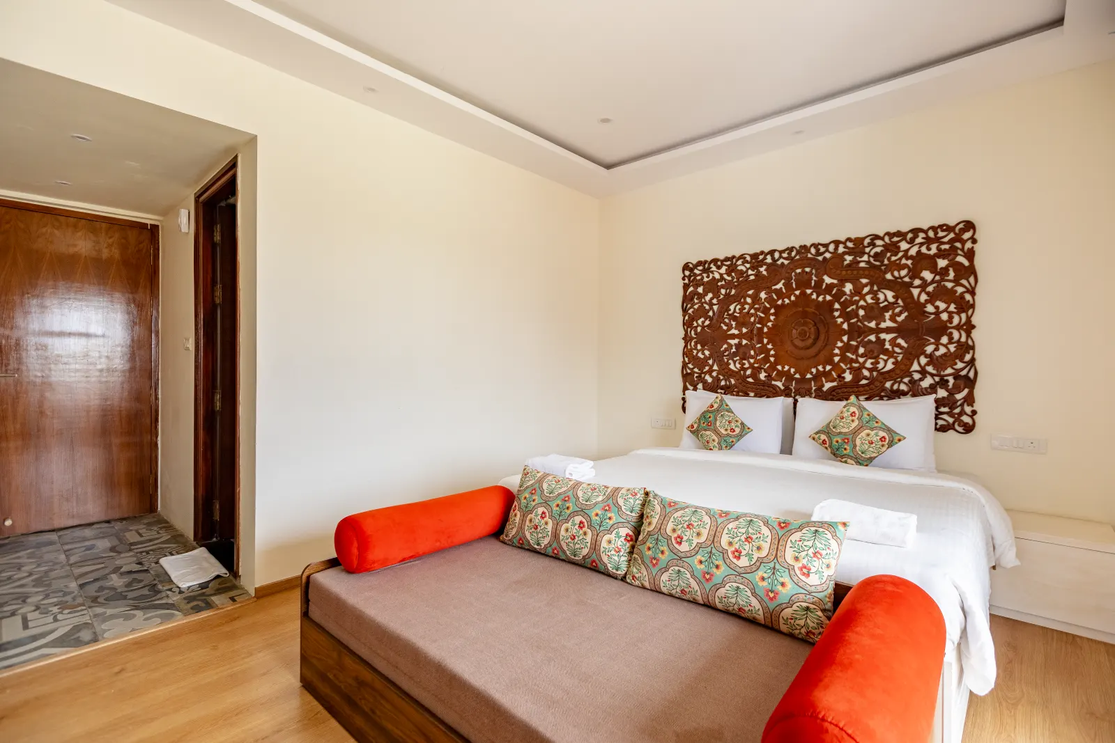 Rumah Residence with carved headboard and lounge seating